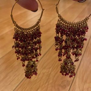 Hindi style looped hanging with chimes earrings color gold with red stones